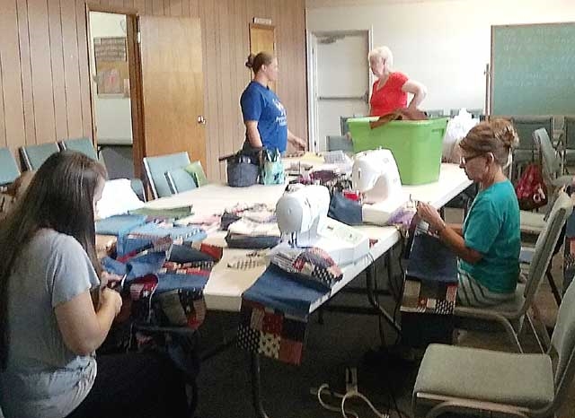 Group making quilts for orphanage